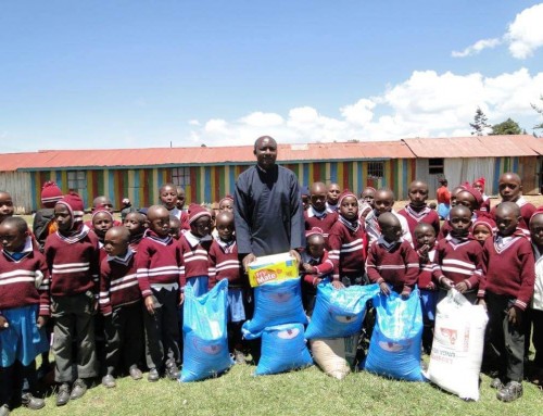 Orthodox priest in Kenya receiving food donations for children children